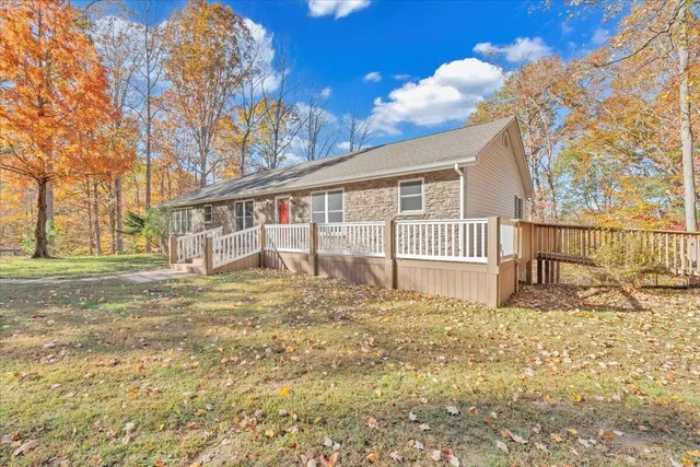 a view of a house with a yard and sitting area