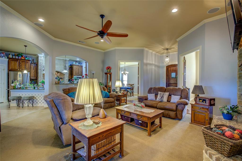 1066 Canyon Lake Road Wills Point, TX 75169 - Photo 5 of 40 a living room with furniture and a chandelier