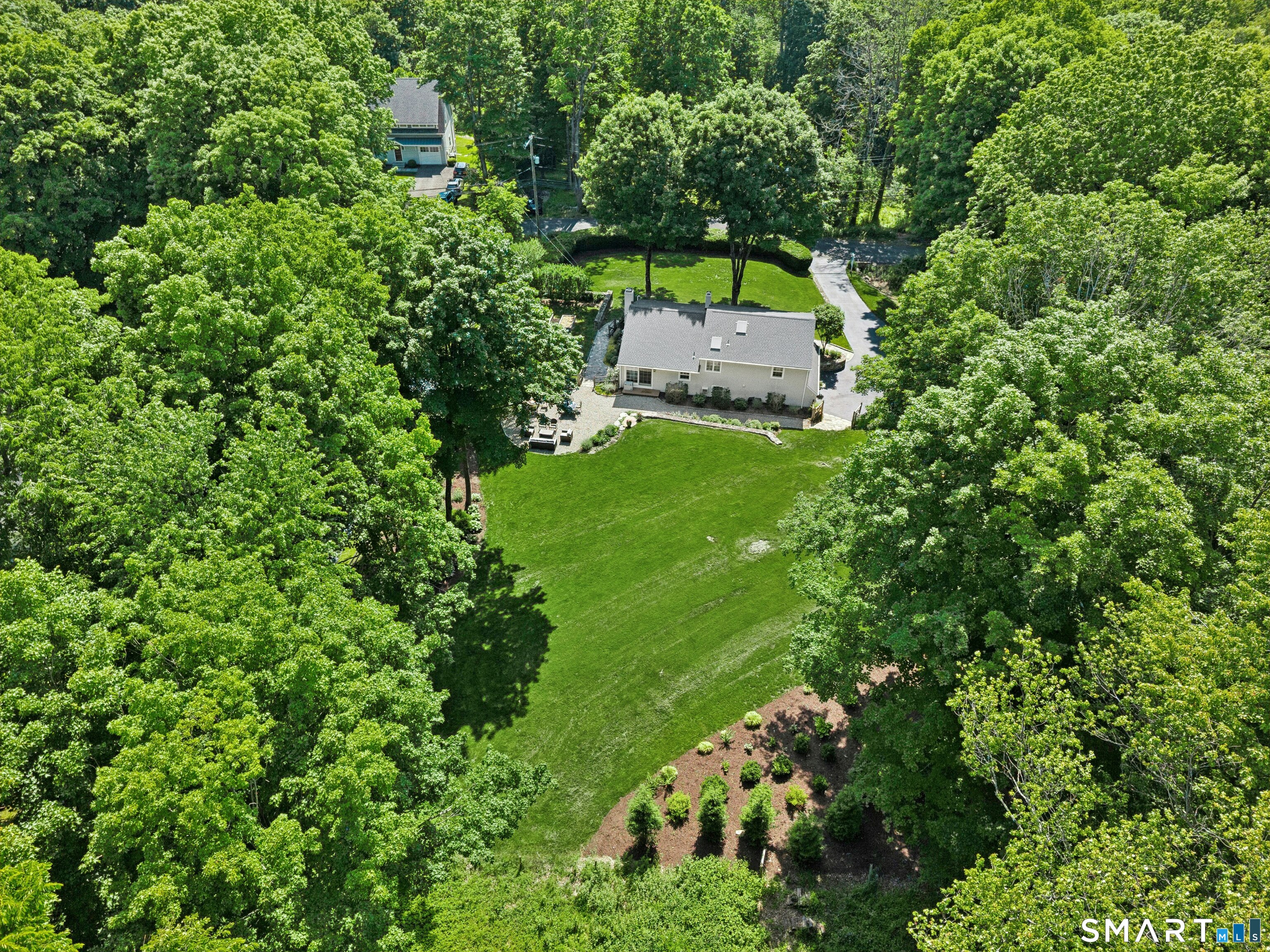 29 Old Farm Road Weston, CT 06883 - Photo 4 of 10 Set on a landscaped, park-like property in a cul-de-sac neighborhood, the home enjoys an idyllic setting for walks and everyday enjoyment.