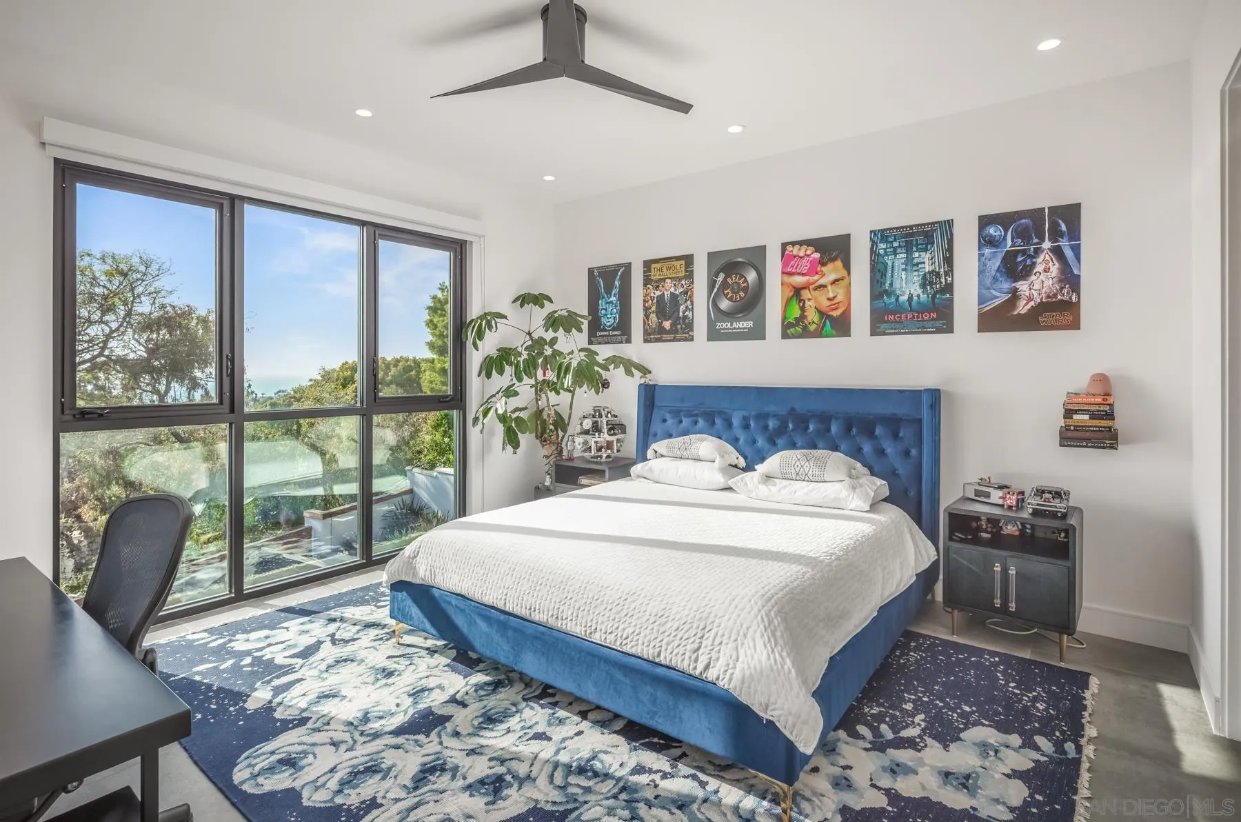 6643 Muirlands Drive La Jolla, CA 92037 - Photo 11 of 16 a bedroom with a large bed and a large window