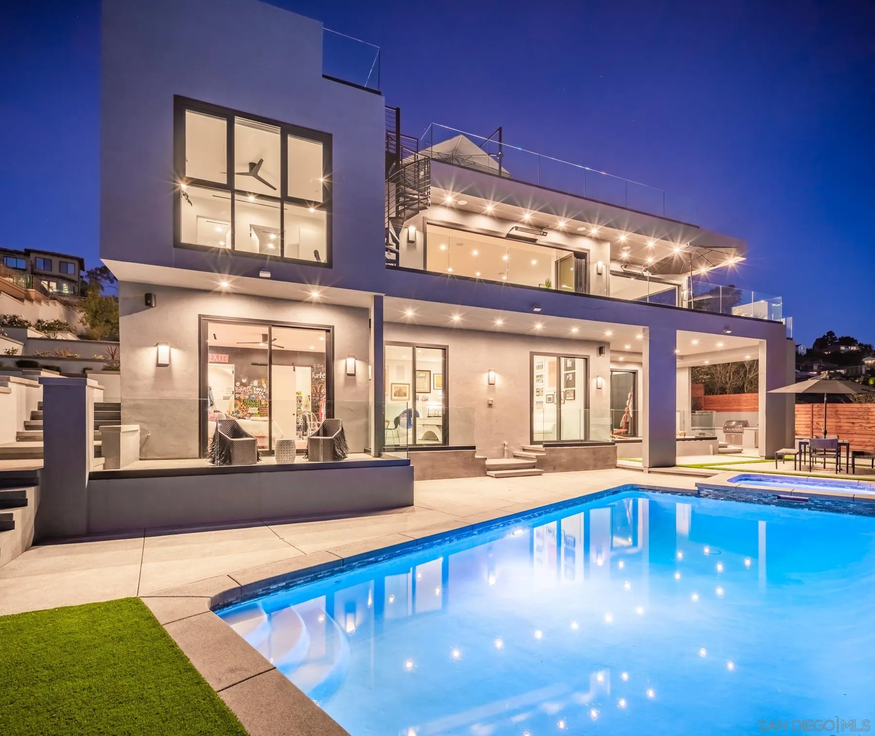 6643 Muirlands Drive La Jolla, CA 92037 - Photo 16 of 16 a view of a living room with kitchen area and large windows