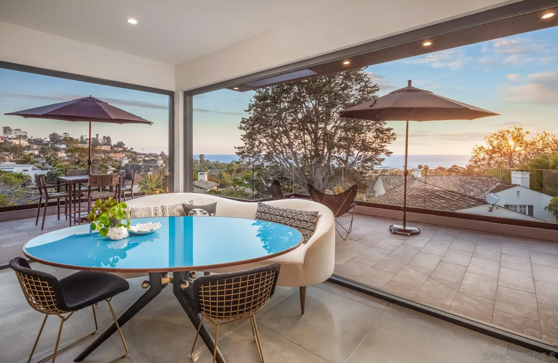 6643 Muirlands Drive La Jolla, CA 92037 - Photo 4 of 16 a dining room with furniture and a floor to ceiling window
