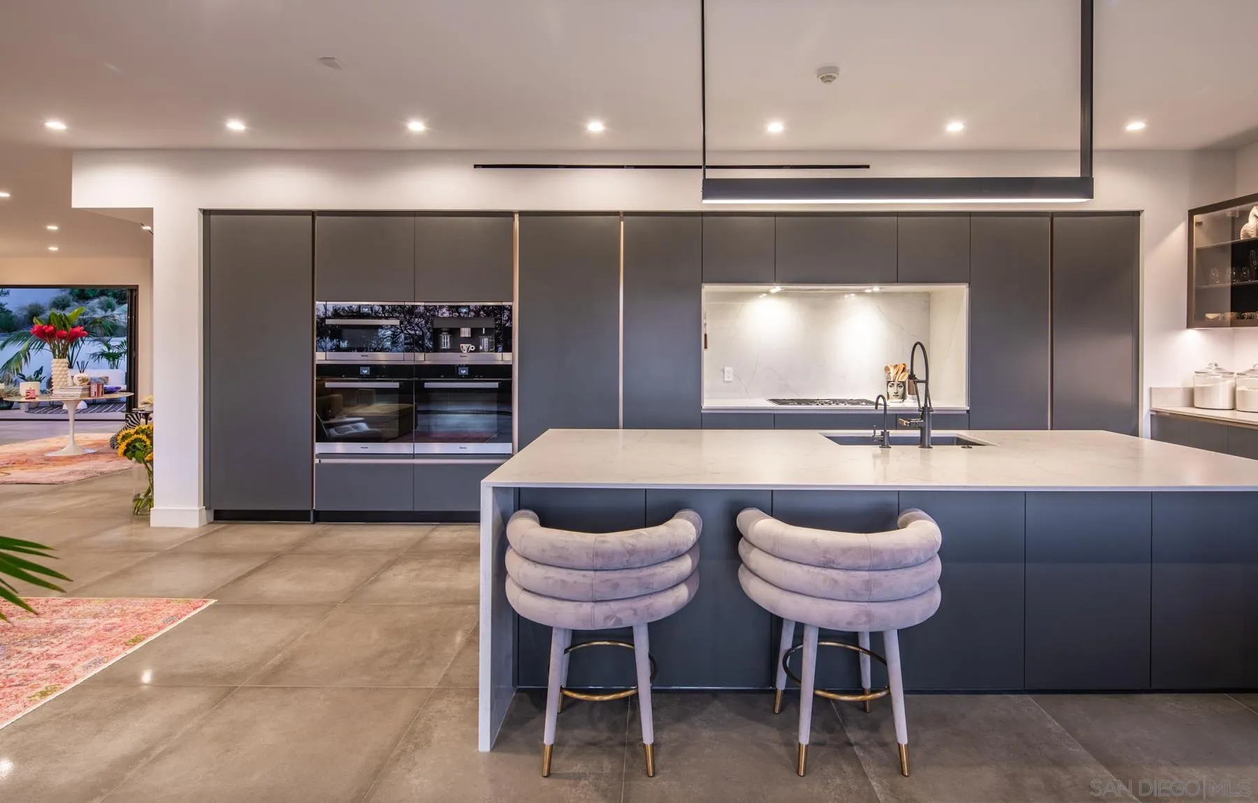 6643 Muirlands Drive La Jolla, CA 92037 - Photo 5 of 16 a kitchen with a dining table chairs and a refrigerator