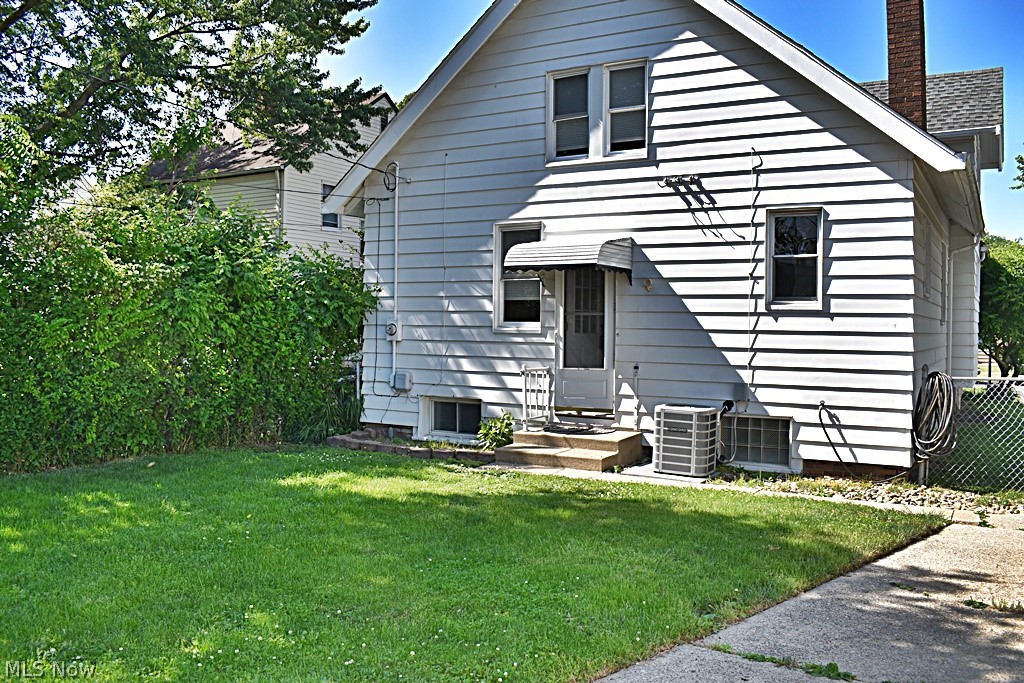 7715 Ackley Road Parma, OH 44129 - Photo 26 of 27 Back of property featuring a yard and central AC