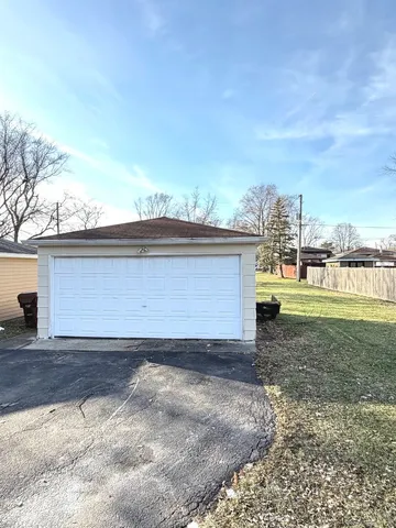 a front view of house with yard and trees
