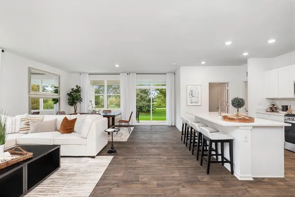 a living room with furniture and large windows