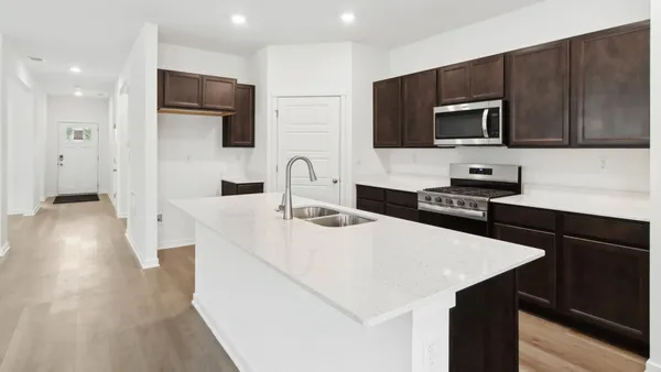 a kitchen with stainless steel appliances a microwave sink and cabinets