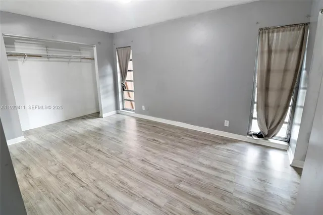 a white toilet sitting next to a white cabinet