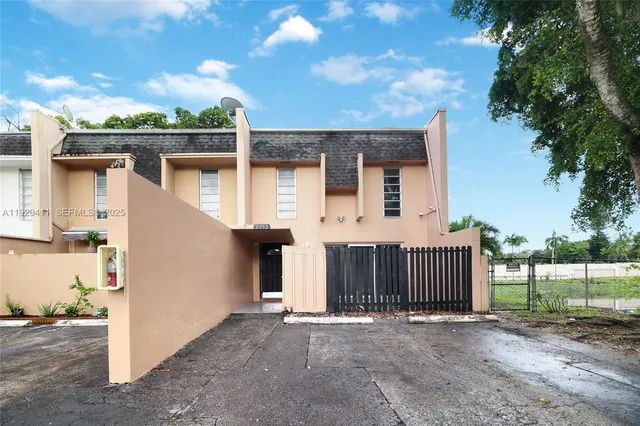 a view of a backyard with wooden fence