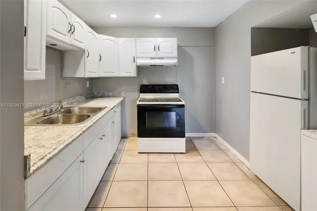 a kitchen with a sink a stove and refrigerator