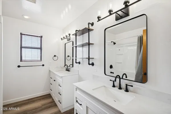 a bathroom with a granite countertop sink a toilet and shower