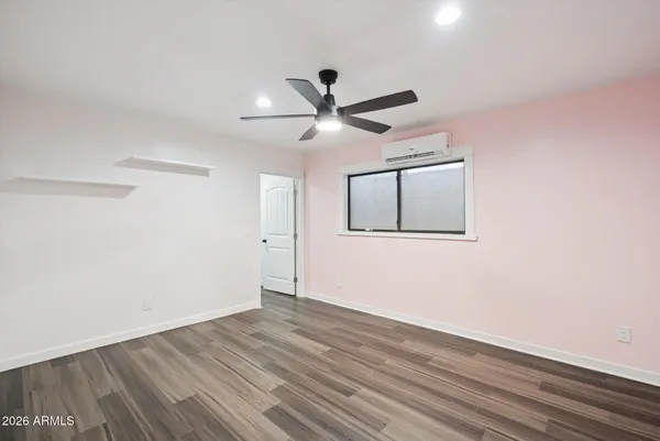 a view of a room with wooden floor and windows