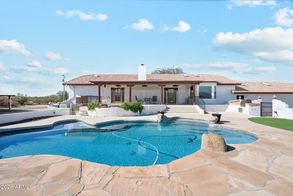 a view of a swimming pool and lounge chairs