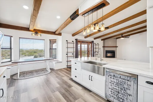 a large white kitchen with a large window