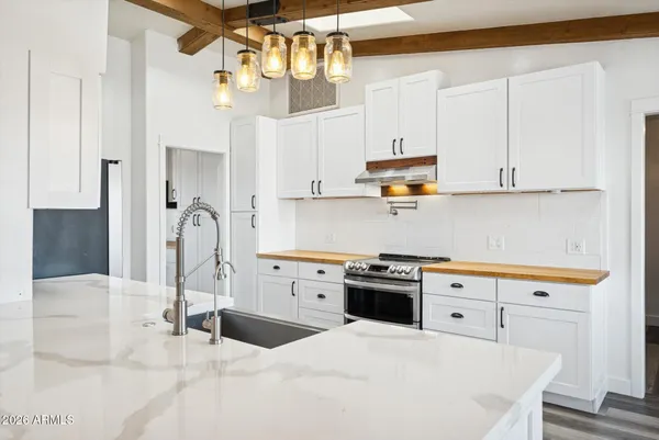 a spacious bathroom with a double vanity sink a mirror and shower