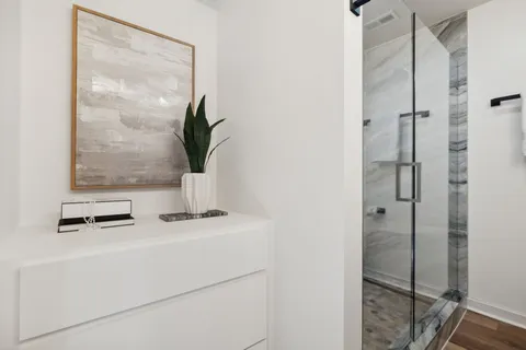 a view of empty room with window and wooden floor