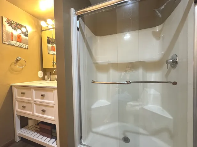a bathroom with a shower and a tub