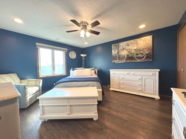 a bedroom with a bed and glass door