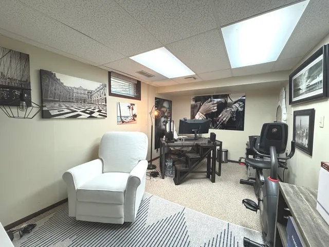 a living room with furniture a piano and a flat screen tv