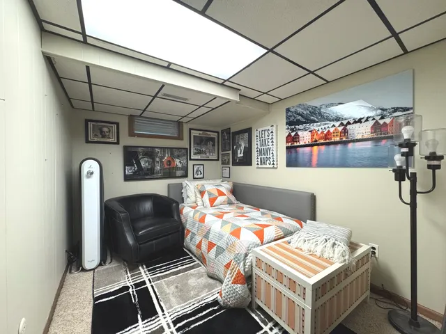 a bedroom with furniture and a baby crib