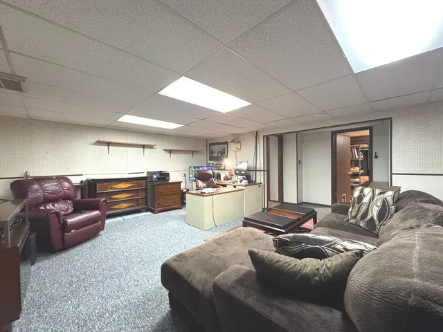a living room with furniture and kitchen view