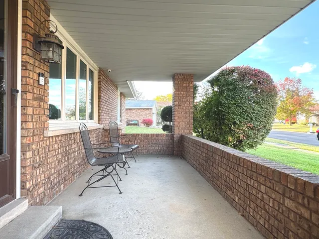 a view of a two chairs in the balcony