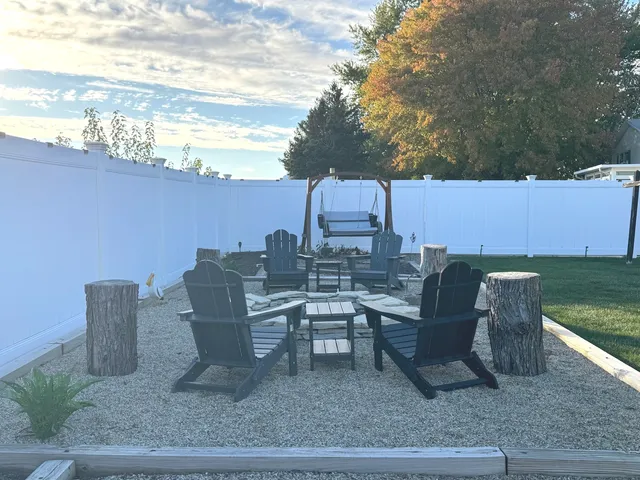 a view of a roof deck with table and chairs and potted plants