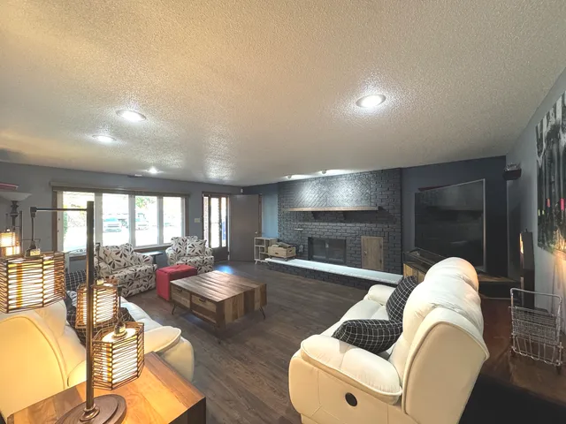 a living room with furniture window and wooden floor