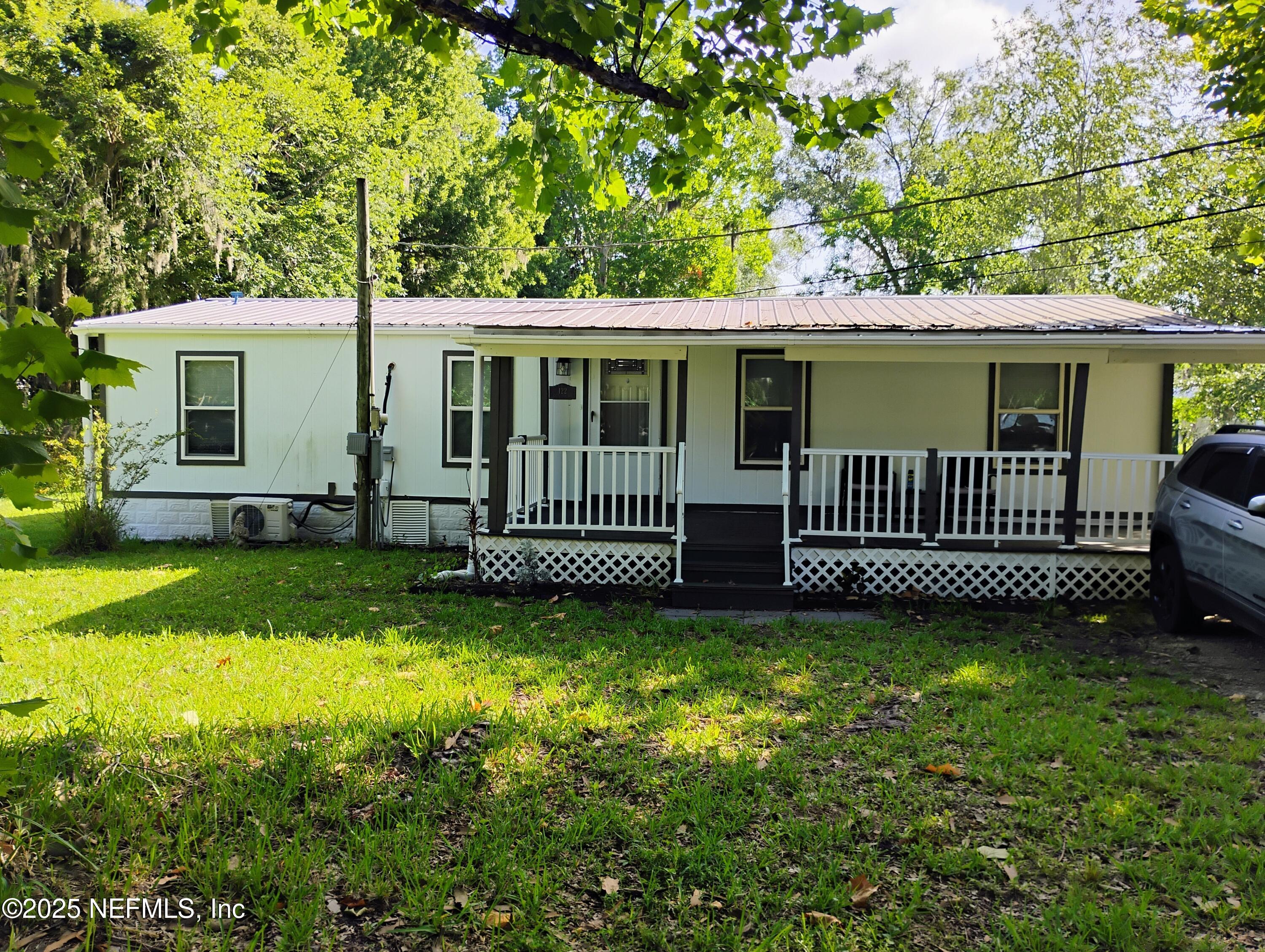 a view of a house with a yard and a garden