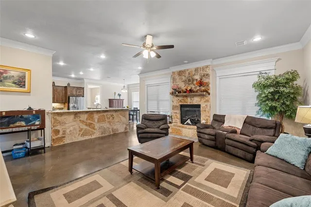 a living room with furniture a fireplace and a flat screen tv