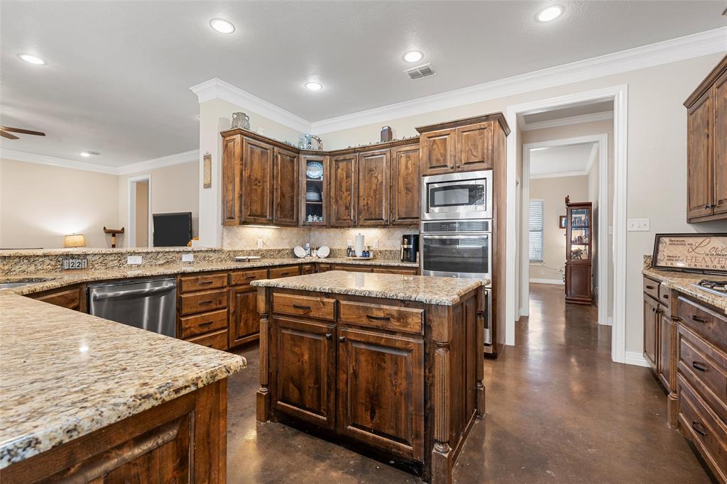 2370 Garrett Lane China Spring, TX 76633 - Photo 15 of 36 a kitchen with stainless steel appliances granite countertop a stove top oven a sink and dishwasher