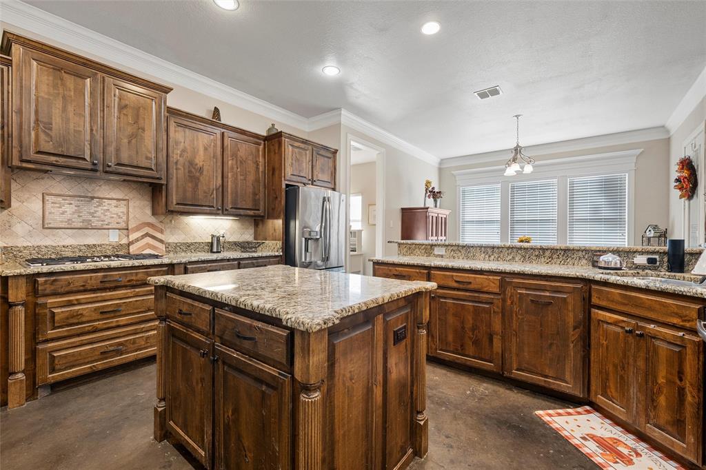 2370 Garrett Lane China Spring, TX 76633 - Photo 17 of 36 a kitchen with kitchen island granite countertop a sink stove and refrigerator