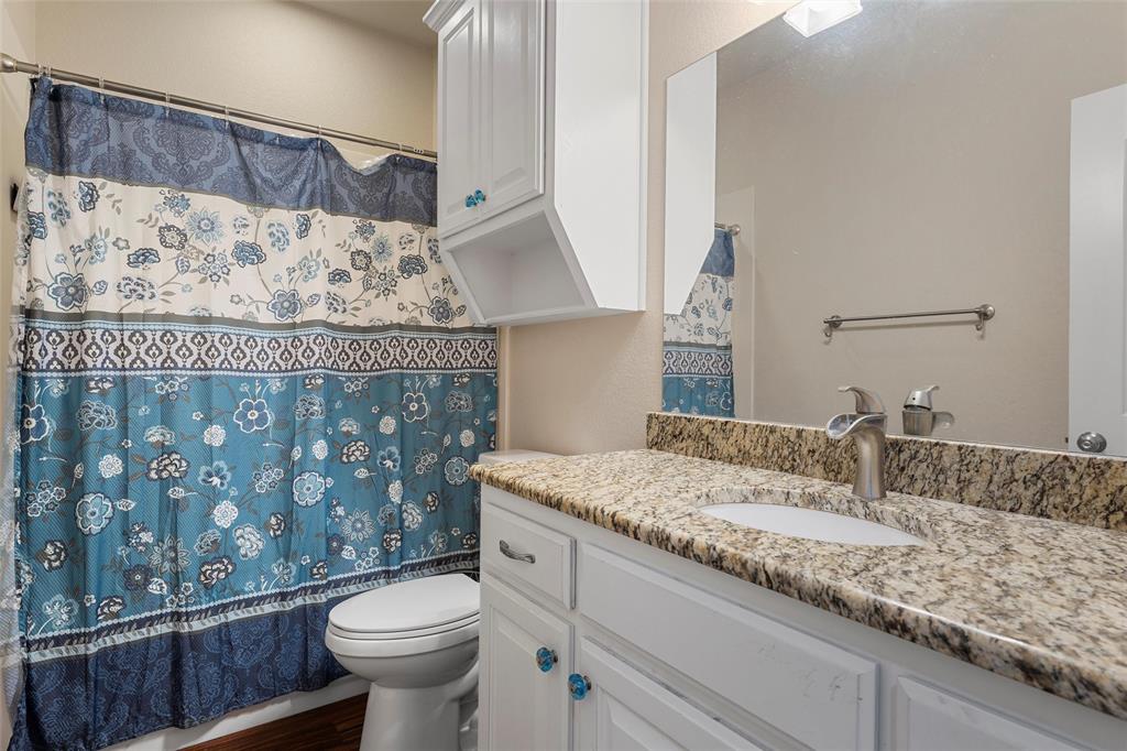 2370 Garrett Lane China Spring, TX 76633 - Photo 25 of 36 a bathroom with a granite countertop sink a toilet and a mirror