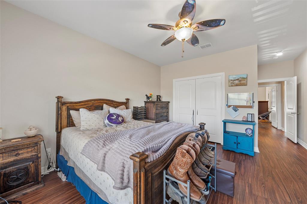 2370 Garrett Lane China Spring, TX 76633 - Photo 27 of 36 a bedroom with a bed and wooden floor