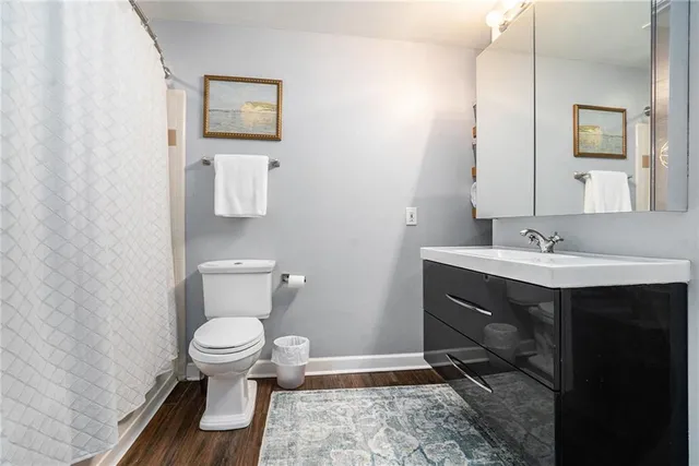 a bathroom with a sink toilet and mirror