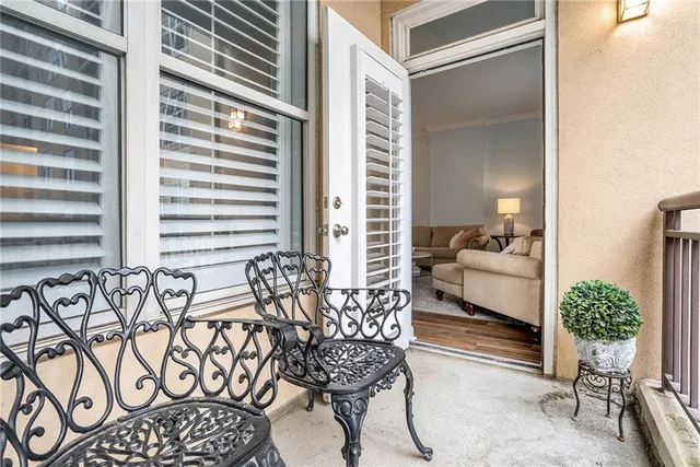 a balcony with furniture and wooden floor