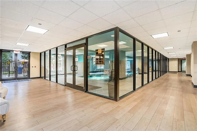 a view of staircase with floor to ceiling window and stairs