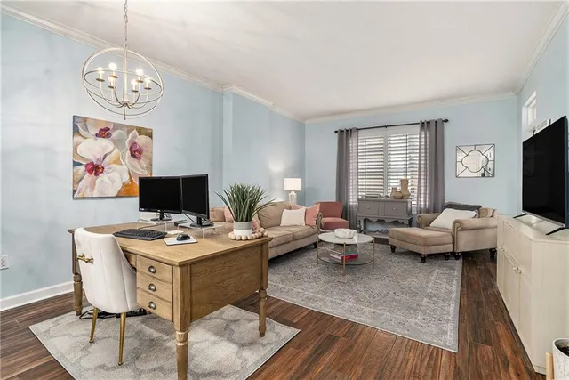 a living room with furniture a flat screen tv and a window