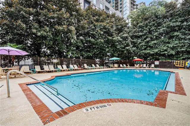 swimming pool view with a seating space