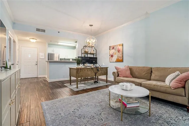 a living room with furniture and kitchen view