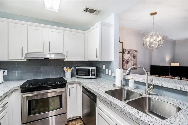 a kitchen with sink a stove and microwave