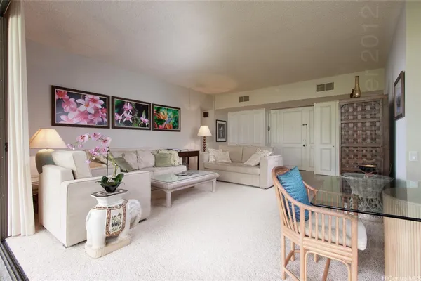 a living room with furniture and a book shelf