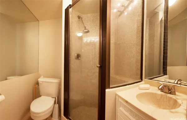 a bathroom with a sink toilet and shower