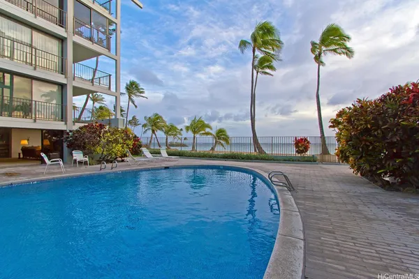 a view of a swimming pool with a yard