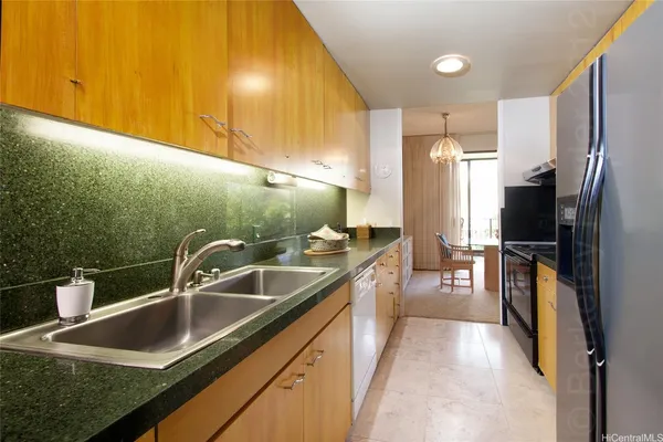 a kitchen with a sink and a refrigerator