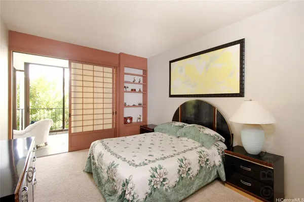 a bed sitting in a bedroom next to a window