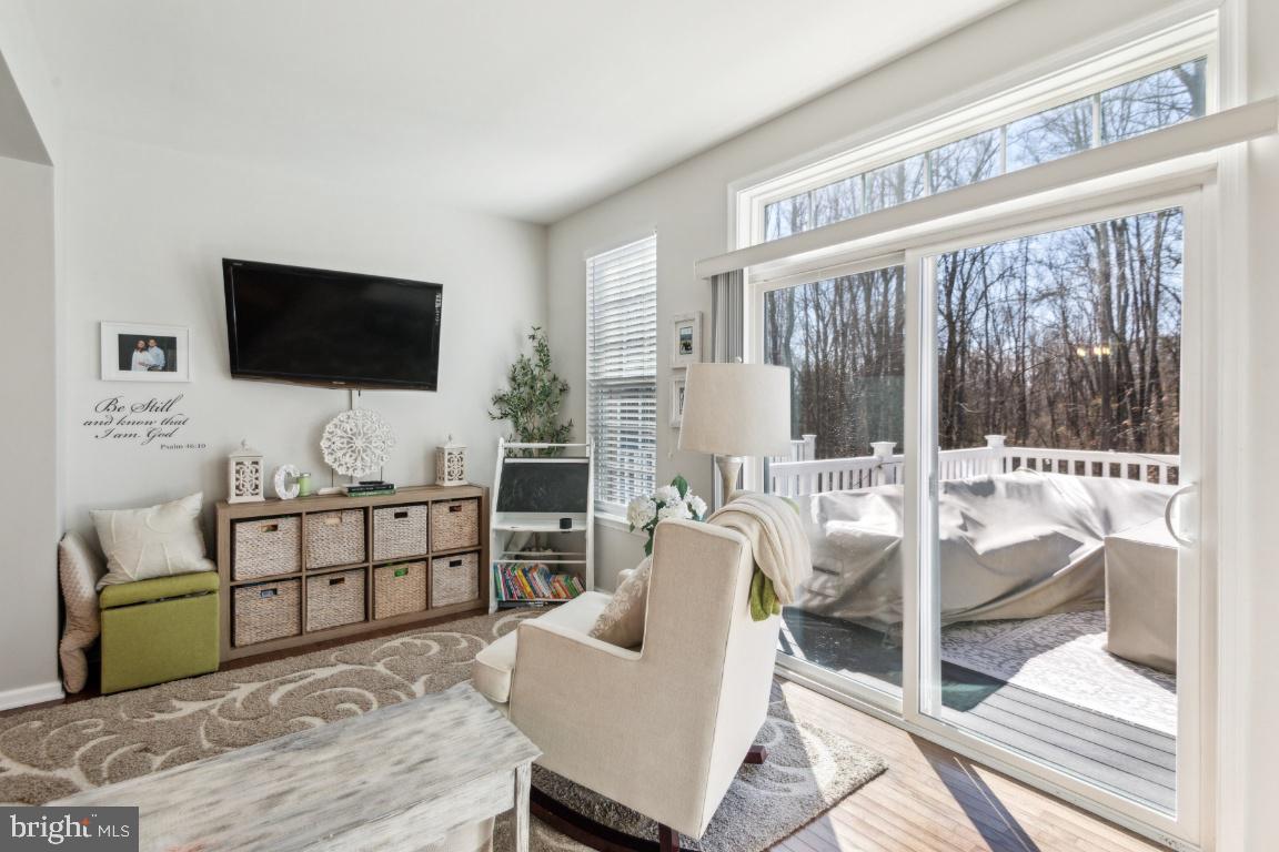 16 Grace Drive Marlton, NJ 08053 - Photo 10 of 24 a living room with furniture a flat screen tv and a floor to ceiling window