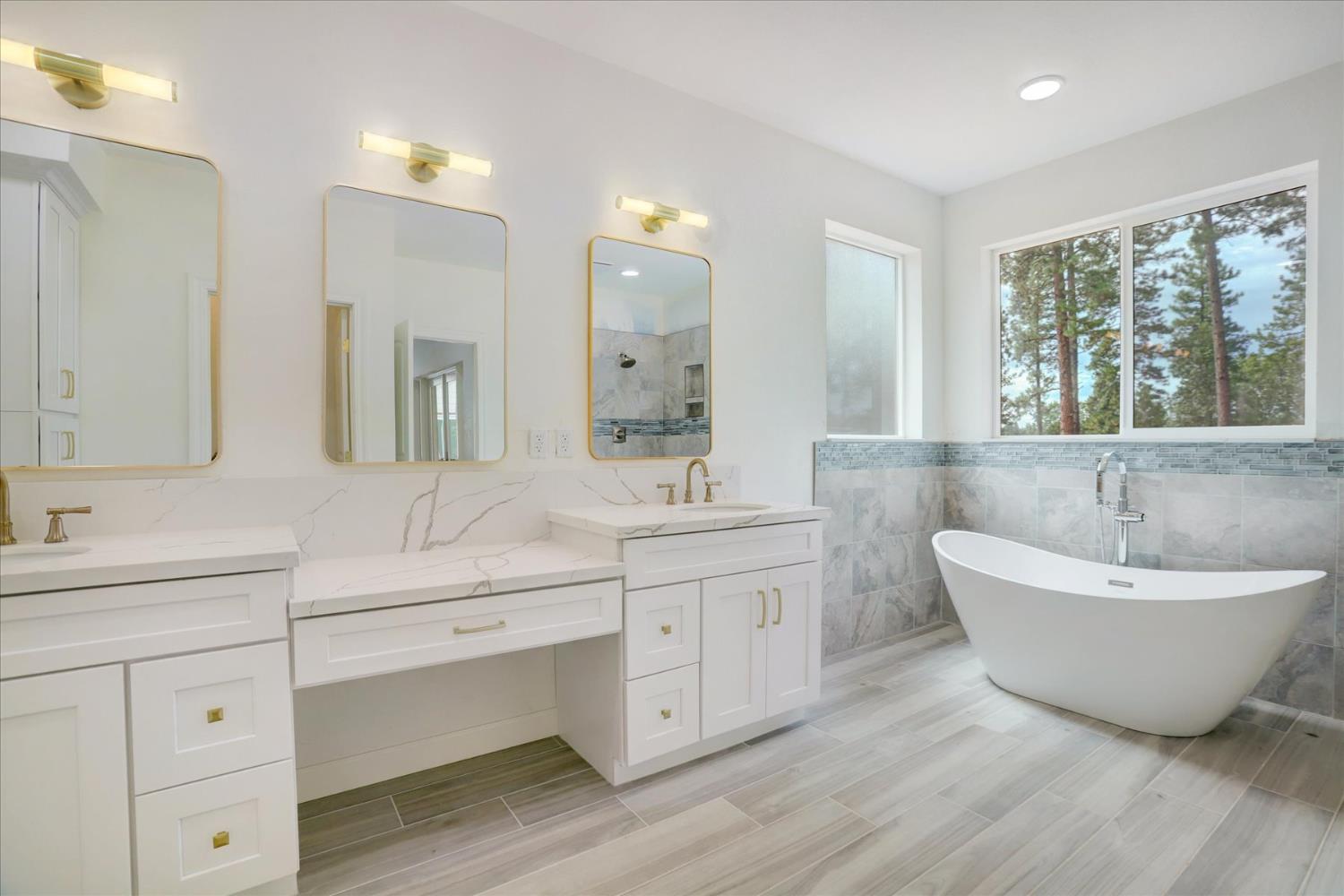 10279 Evergreen Ranch Court Grass Valley, CA 95949 - Photo 13 of 79 a spacious bathroom with a double vanity sink large mirror and a bathtub