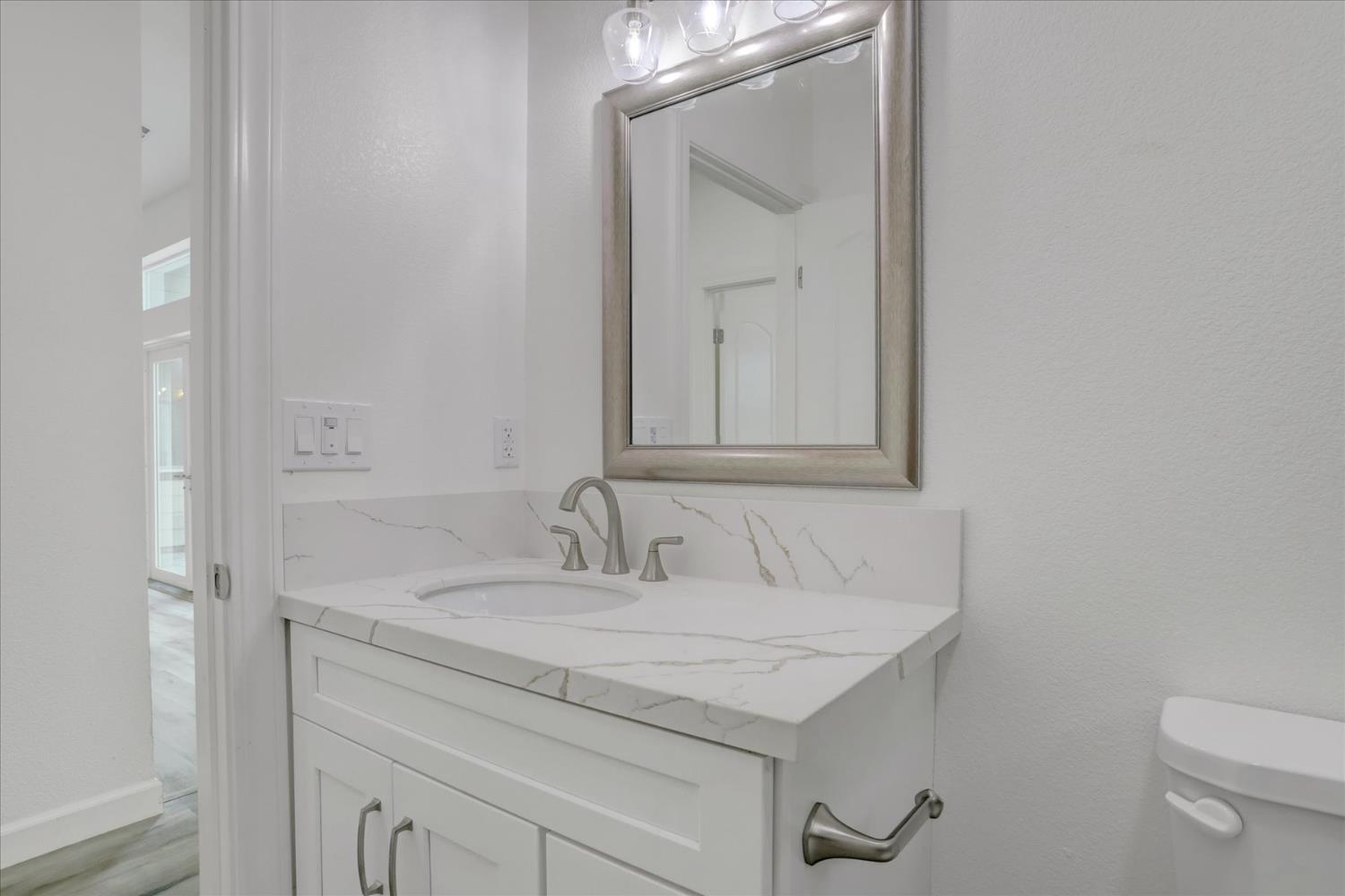 10279 Evergreen Ranch Court Grass Valley, CA 95949 - Photo 17 of 79 a bathroom with a granite countertop sink and a toilet