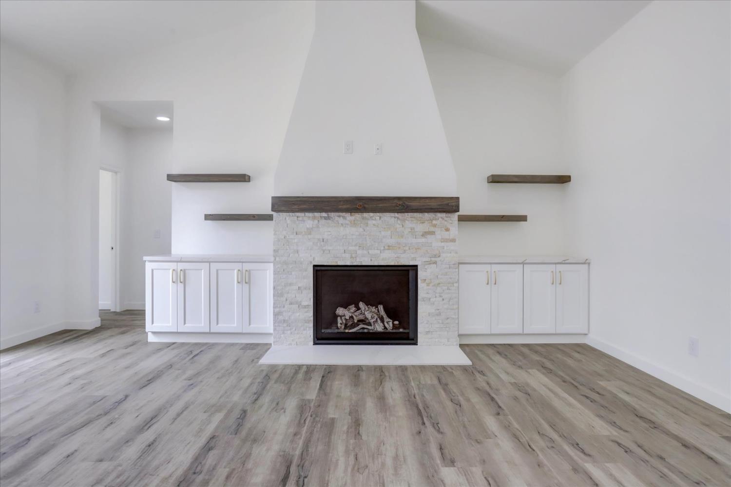 10279 Evergreen Ranch Court Grass Valley, CA 95949 - Photo 25 of 79 a living room with a fireplace and wooden floor